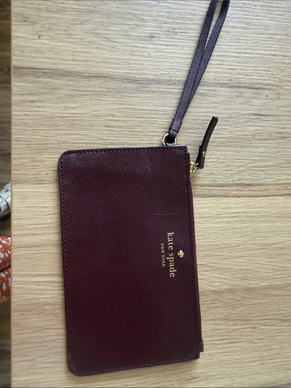 kate spade burgundy wristlet clutch with gold logo